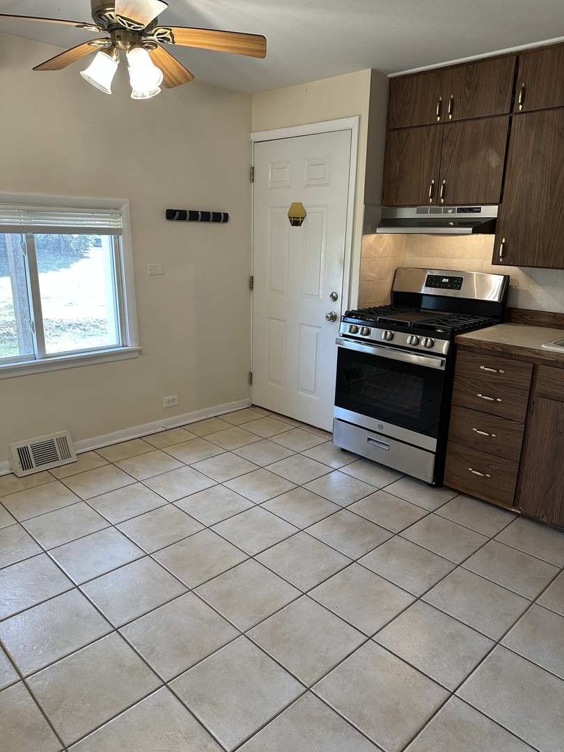16664 West Aptakisic Road, Unit 1E Lincolnshire, IL 60069 - Photo 3 of 9 a kitchen with a sink and cabinets