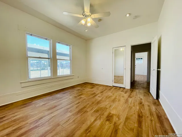 wooden floor in an empty room with a window