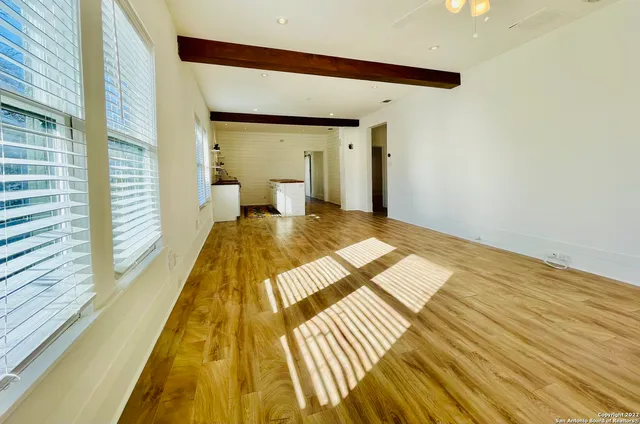 a view of a bedroom with wooden floor and furniture