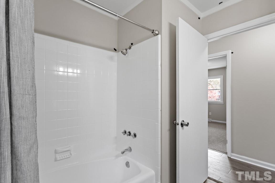 4116 Kilcullen Drive Raleigh, NC 27604 - Photo 20 of 28 a bathroom with a bathtub and shower