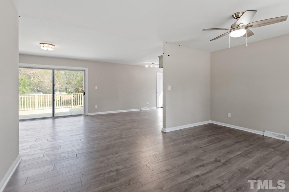 4116 Kilcullen Drive Raleigh, NC 27604 - Photo 2 of 28 an empty room with wooden floor fan and windows