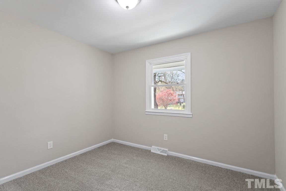 4116 Kilcullen Drive Raleigh, NC 27604 - Photo 21 of 28 an empty room with a window