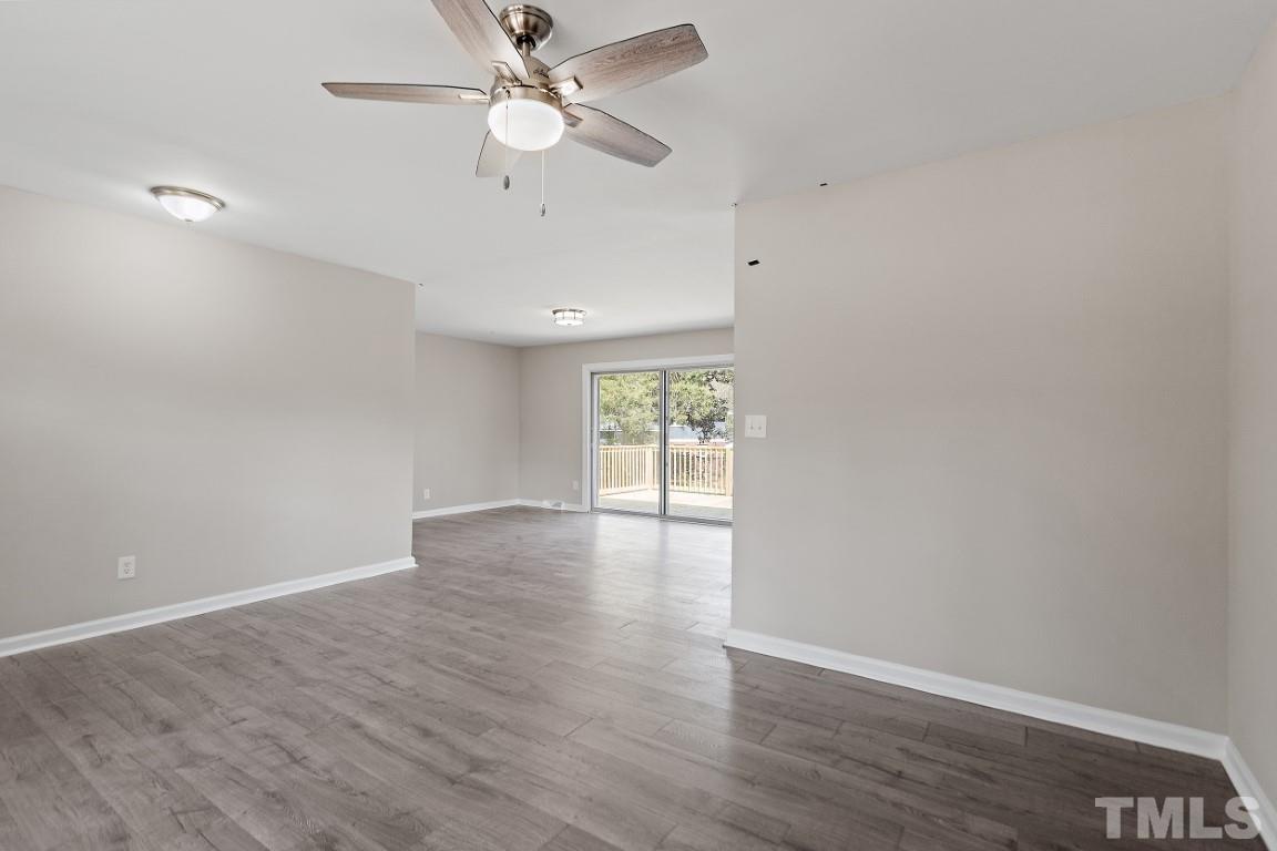 4116 Kilcullen Drive Raleigh, NC 27604 - Photo 3 of 28 an empty room with wooden floor fan and windows