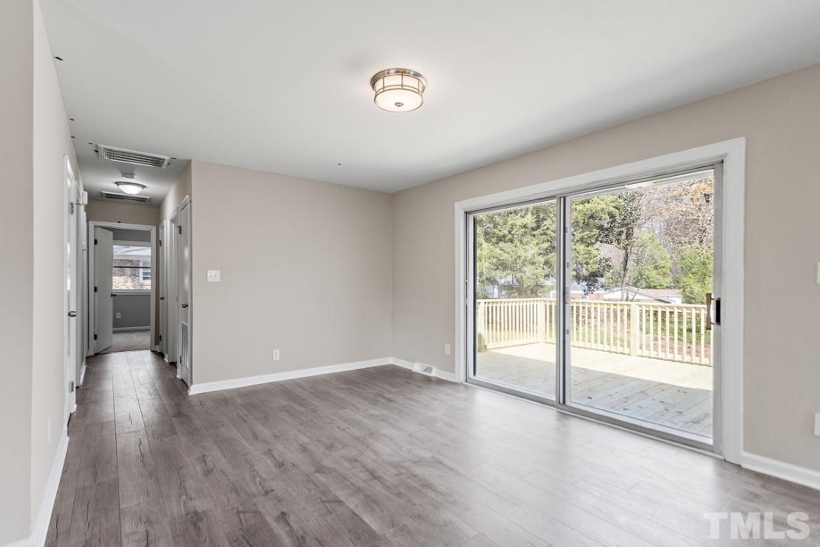 4116 Kilcullen Drive Raleigh, NC 27604 - Photo 10 of 28 an empty room with wooden floor and windows