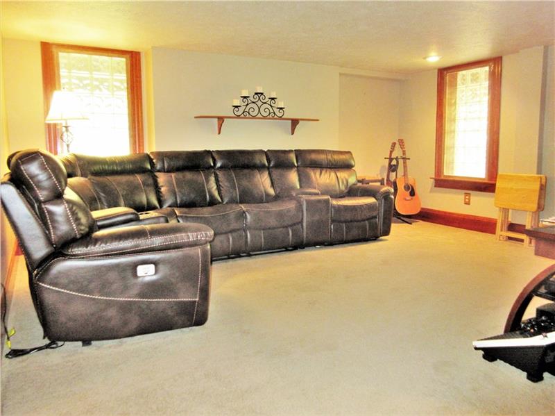 230 Compton Road Sewickley, PA 15143 - Photo 11 of 24 Extra entertainment space can be found in this carpeted, lower level family room with glass block windows, an entrance to the side deck, and a full bathroom close by!