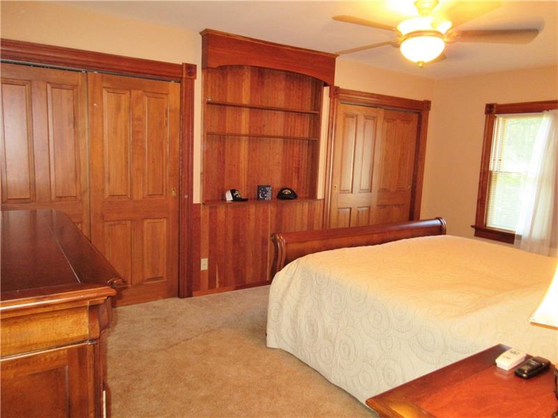 230 Compton Road Sewickley, PA 15143 - Photo 15 of 24 The master bedroom features two double closets with built in organizers, built in shelves with wainscoting, and a lighted ceiling fan.