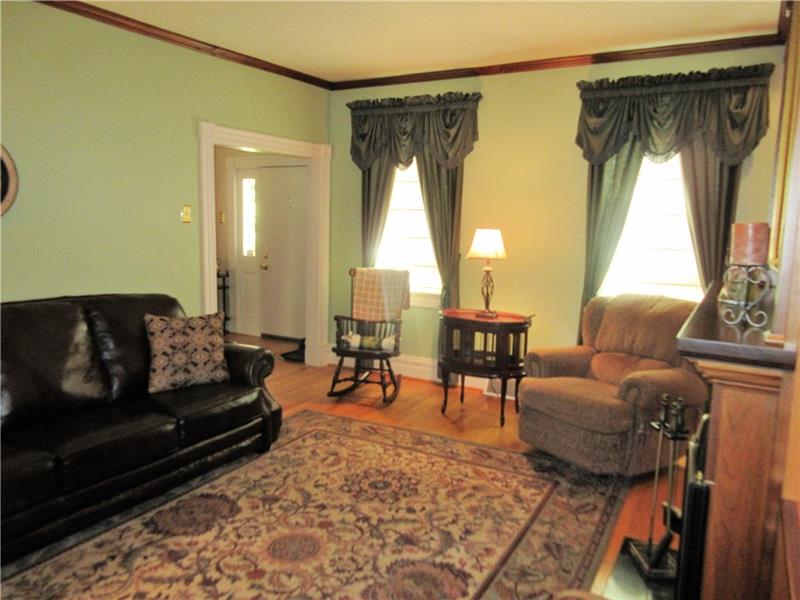 230 Compton Road Sewickley, PA 15143 - Photo 3 of 24 This inviting living room has hardwood floors, crown moulding and a cozy gas fireplace.