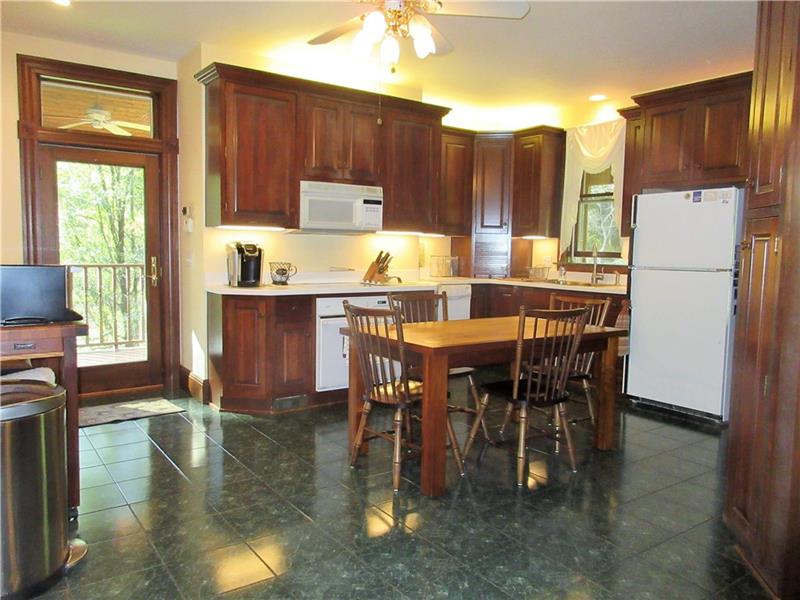 230 Compton Road Sewickley, PA 15143 - Photo 5 of 24 This eat-in kitchen boasts lovely cabinetry with lighting underneath them, a ceramic tile floor, recessed lights, a lighted ceiling fan and two convenient entrances to the outside covered deck.