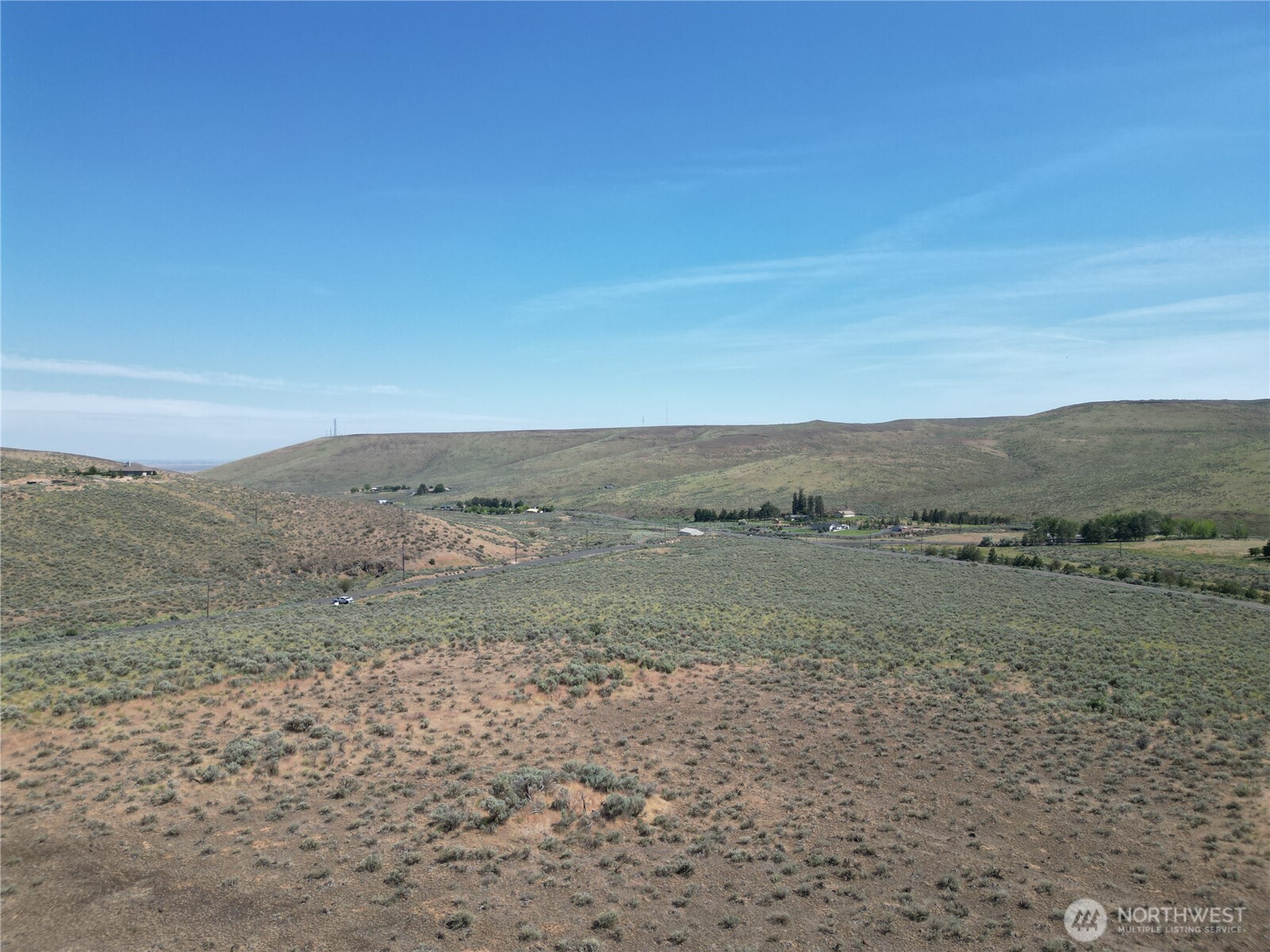 a view of a field with a mountain in the background