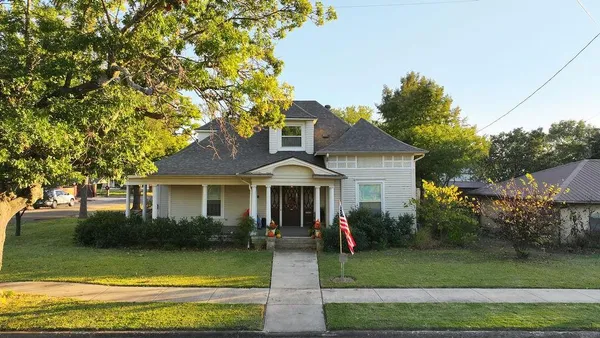 a front view of a house with a yard