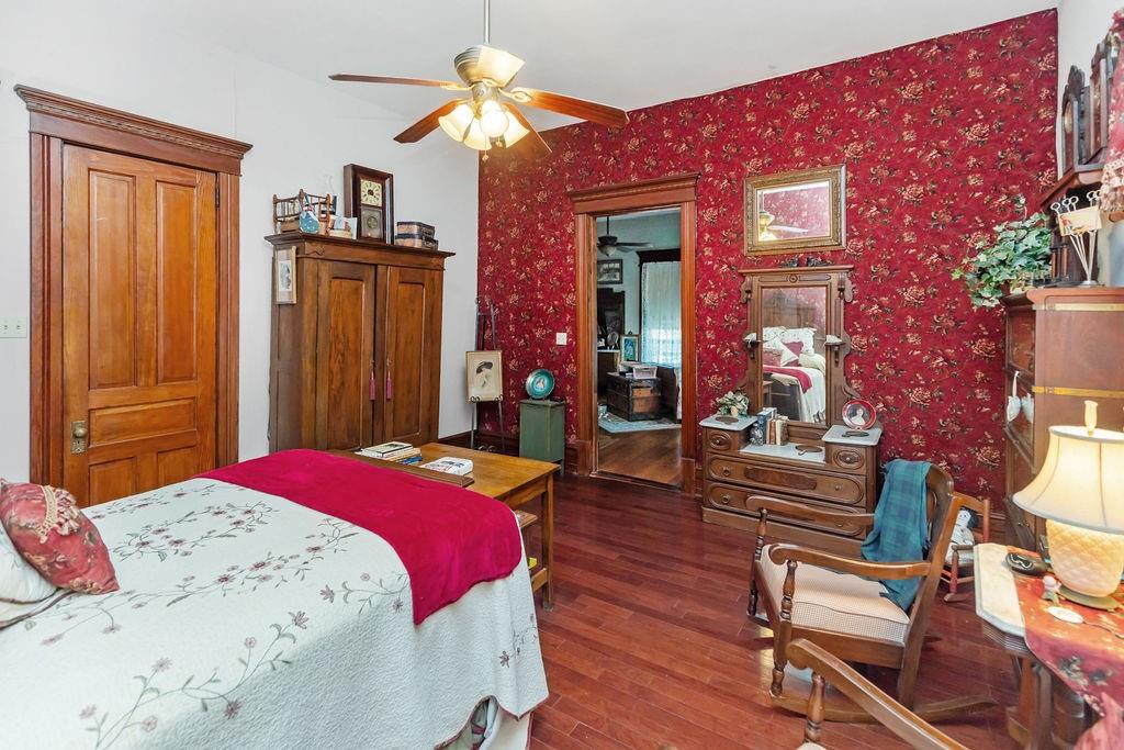 704 East Main Street Honey Grove, TX 75446 - Photo 12 of 38 a bedroom with a bed and wooden floor