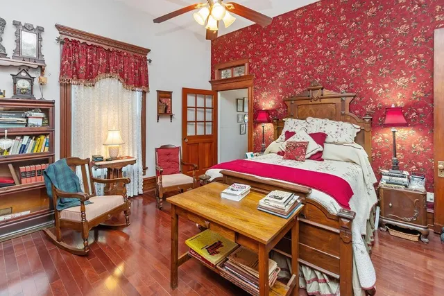 a bedroom with a bed and a chandelier