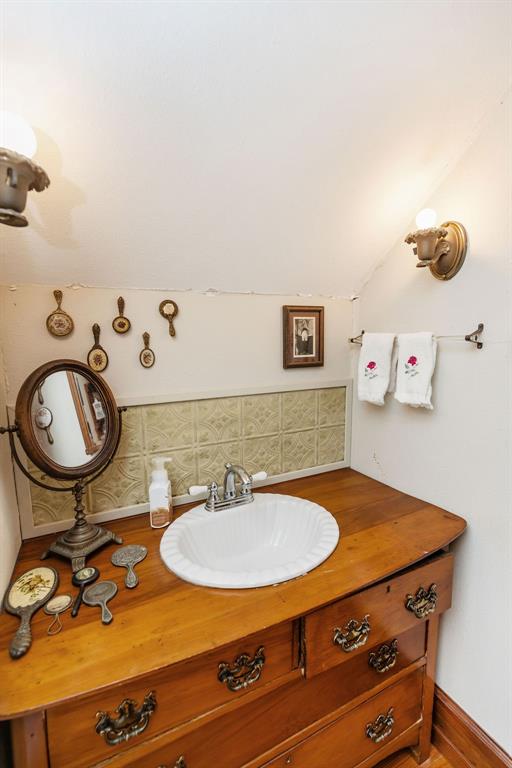 704 East Main Street Honey Grove, TX 75446 - Photo 16 of 38 a bathroom with a sink mirror and vanity