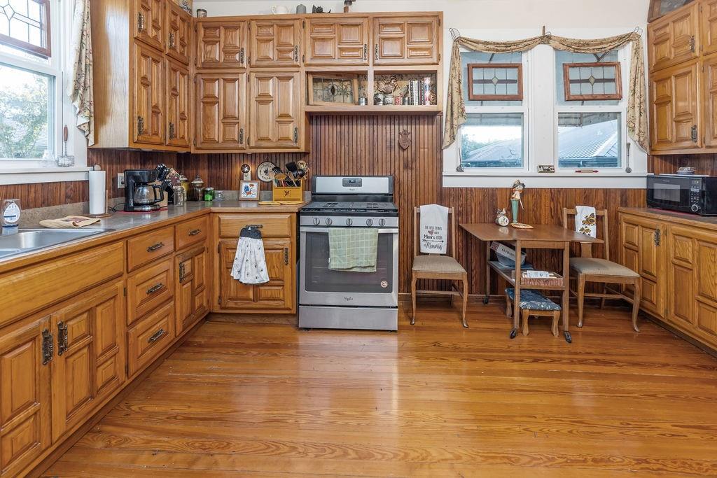 704 East Main Street Honey Grove, TX 75446 - Photo 17 of 38 a kitchen with stainless steel appliances granite countertop a stove and a refrigerator