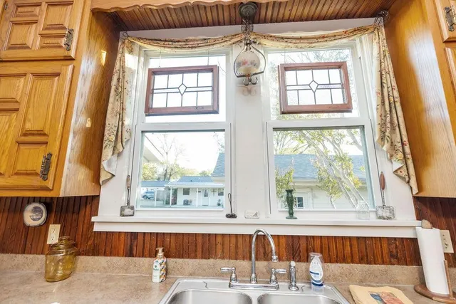 a kitchen with stainless steel appliances a refrigerator sink and wooden floor