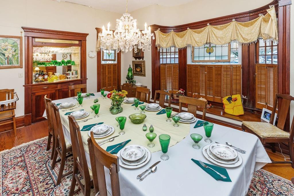 704 East Main Street Honey Grove, TX 75446 - Photo 20 of 38 a dining room with furniture a large window and wooden floor