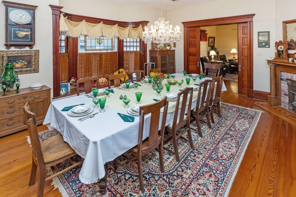 704 East Main Street Honey Grove, TX 75446 - Photo 22 of 38 a view of a dining room with furniture a chandelier and wooden floor