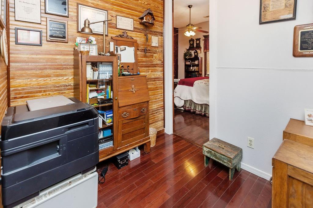 704 East Main Street Honey Grove, TX 75446 - Photo 26 of 38 a reading room with wooden floor and furniture