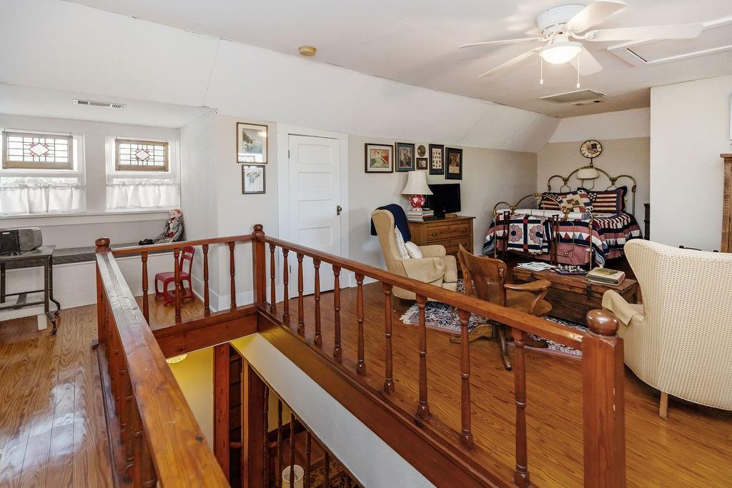 704 East Main Street Honey Grove, TX 75446 - Photo 28 of 38 a view of a hallway with wooden floor and staircase