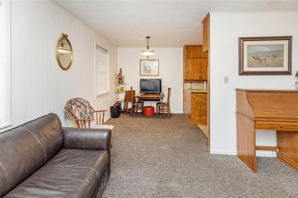 704 East Main Street Honey Grove, TX 75446 - Photo 34 of 38 a living room with furniture and a chandelier