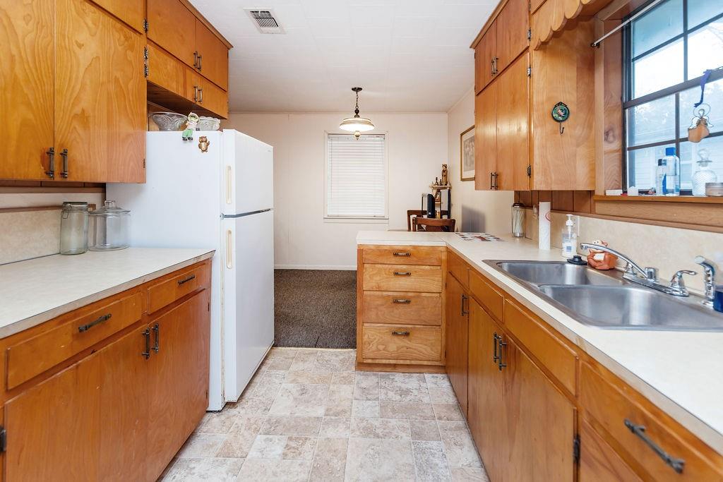 704 East Main Street Honey Grove, TX 75446 - Photo 36 of 38 a kitchen with cabinets and window