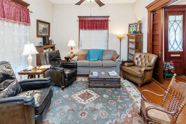 a living room with furniture a flat screen tv and a window