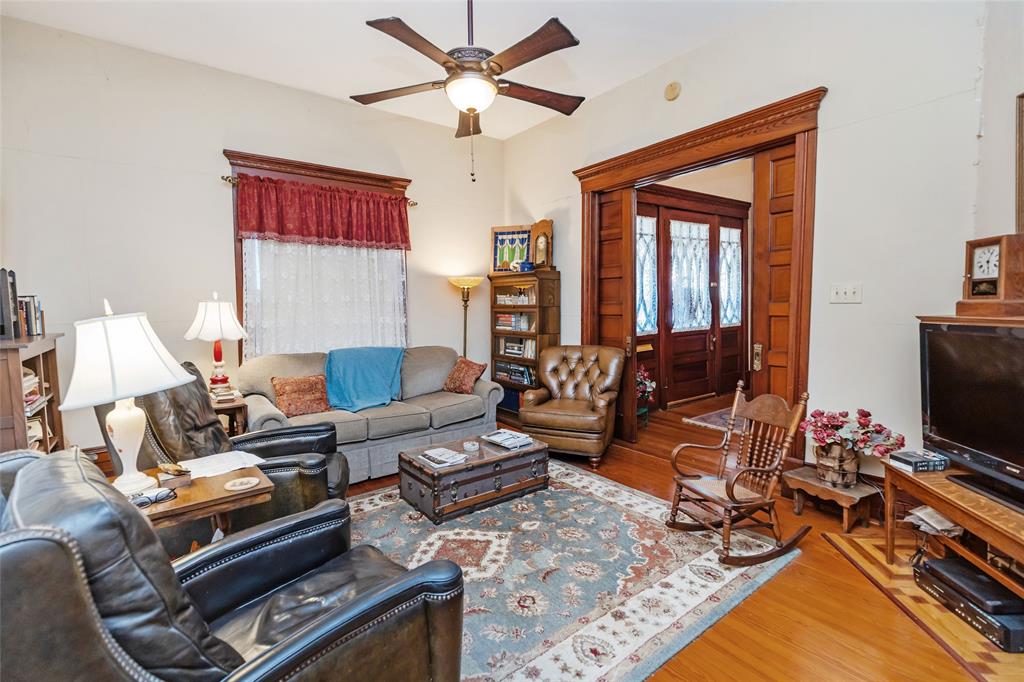 704 East Main Street Honey Grove, TX 75446 - Photo 8 of 38 a living room with furniture a flat screen tv and a window