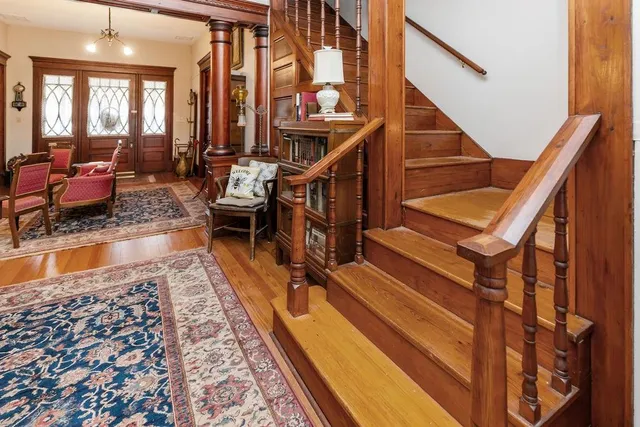a living room with furniture a rug and a book shelf