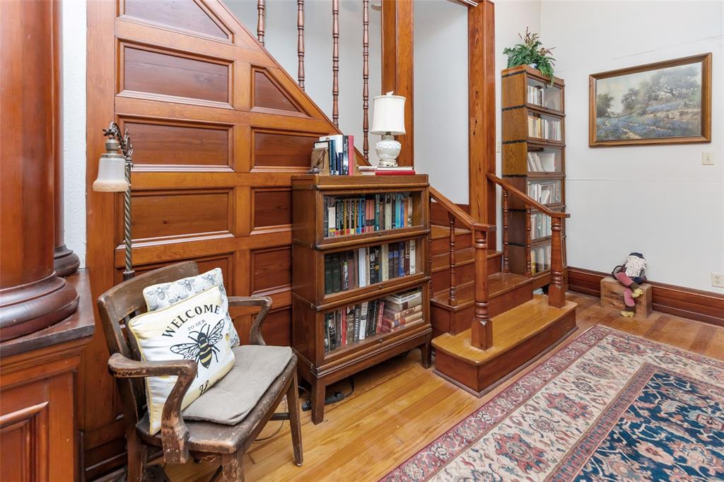 704 East Main Street Honey Grove, TX 75446 - Photo 10 of 38 a living room with furniture a rug and a book shelf
