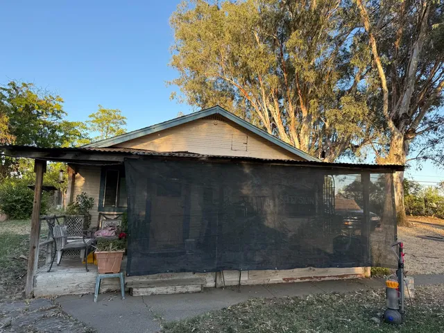 a house with trees in the background