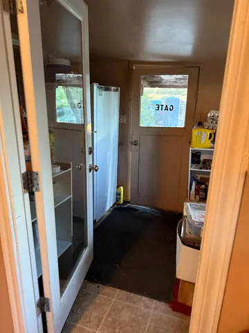 a hallway with chairs sitting next to a window