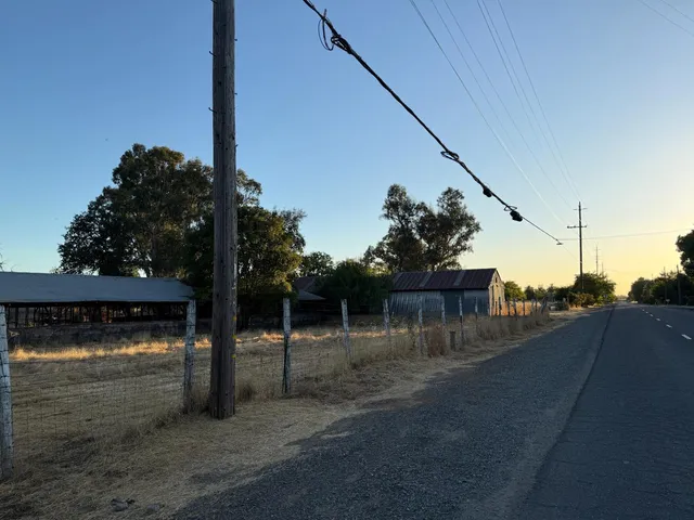 a view of a patio with a table and chairs couches under an umbrella