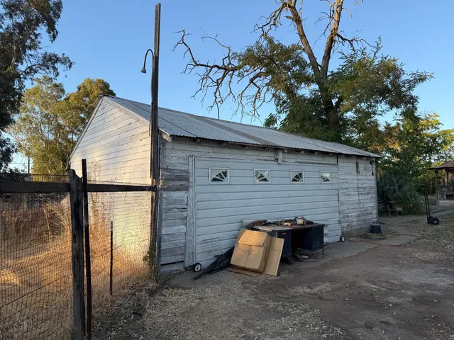 a view of a tree in front of a yard