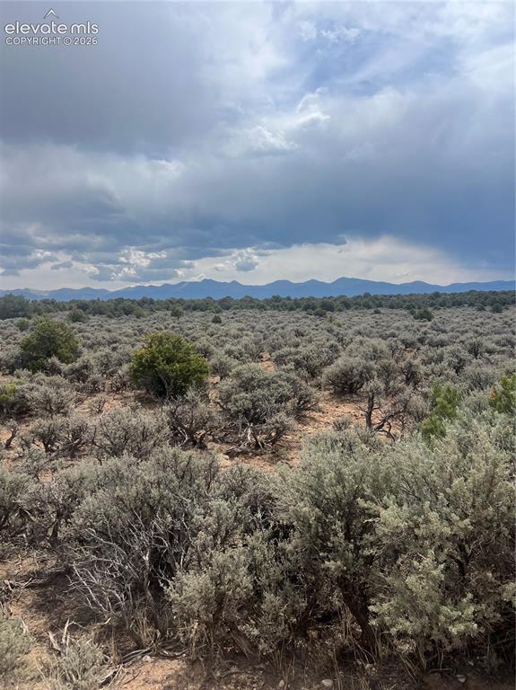 Lot 8 Melby Ranch Road San Luis, CO 81152 - Photo 18 of 20 Expansive natural landscape featuring desert brush and distant mountain ranges under a partly cloudy sky