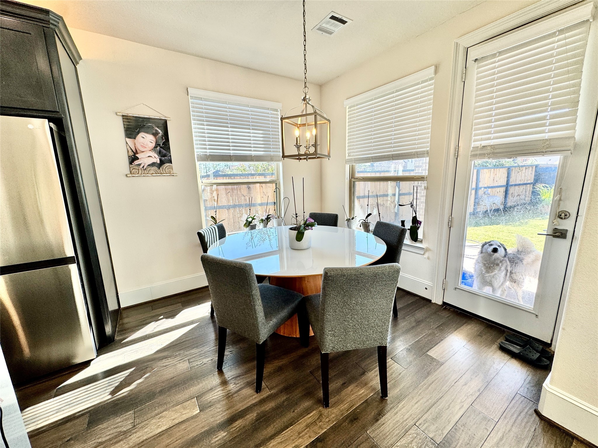 16803 Bark Cabin Drive Humble, TX 77346 - Photo 8 of 27 a dining room with furniture a chandelier and wooden floor