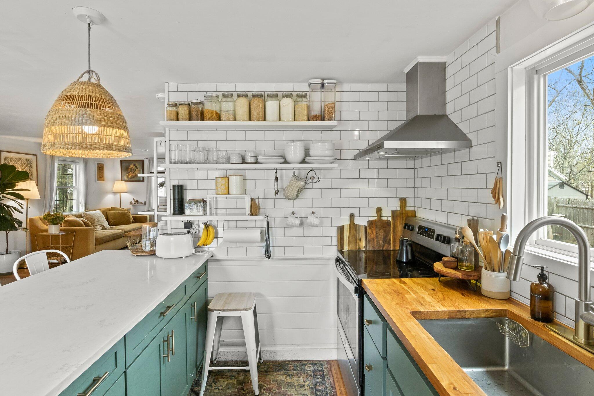 582 Massasoit Road Eastham, MA 02642 - Photo 11 of 45 a kitchen with a sink a stove and a wooden floor