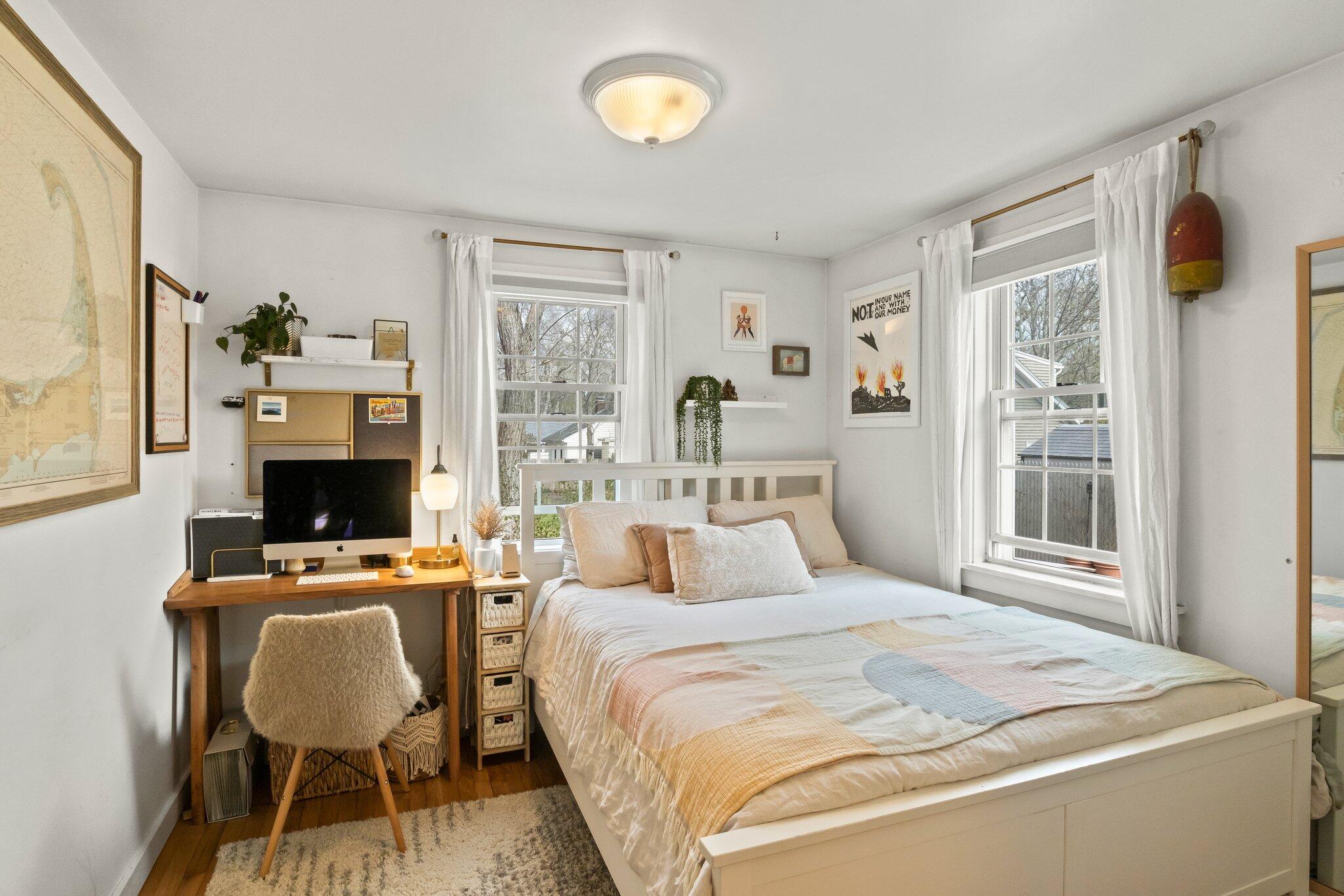 582 Massasoit Road Eastham, MA 02642 - Photo 15 of 45 a bedroom with a bed and a chair with the outer view