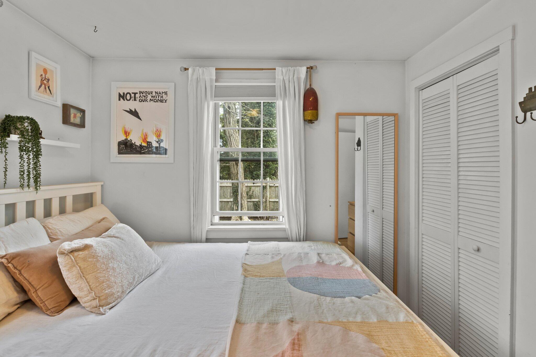 582 Massasoit Road Eastham, MA 02642 - Photo 17 of 45 a bedroom with a bed and a window