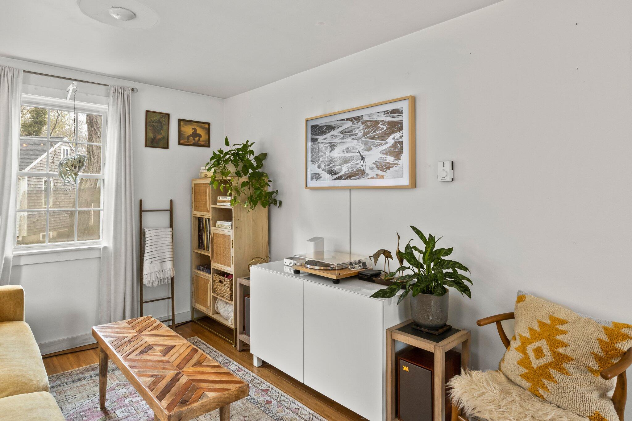 582 Massasoit Road Eastham, MA 02642 - Photo 21 of 45 a dining room with furniture and a potted plant