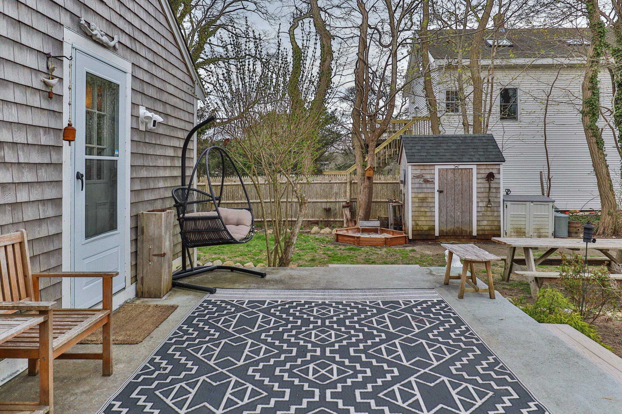 582 Massasoit Road Eastham, MA 02642 - Photo 26 of 45 a view of a brick house with a yard