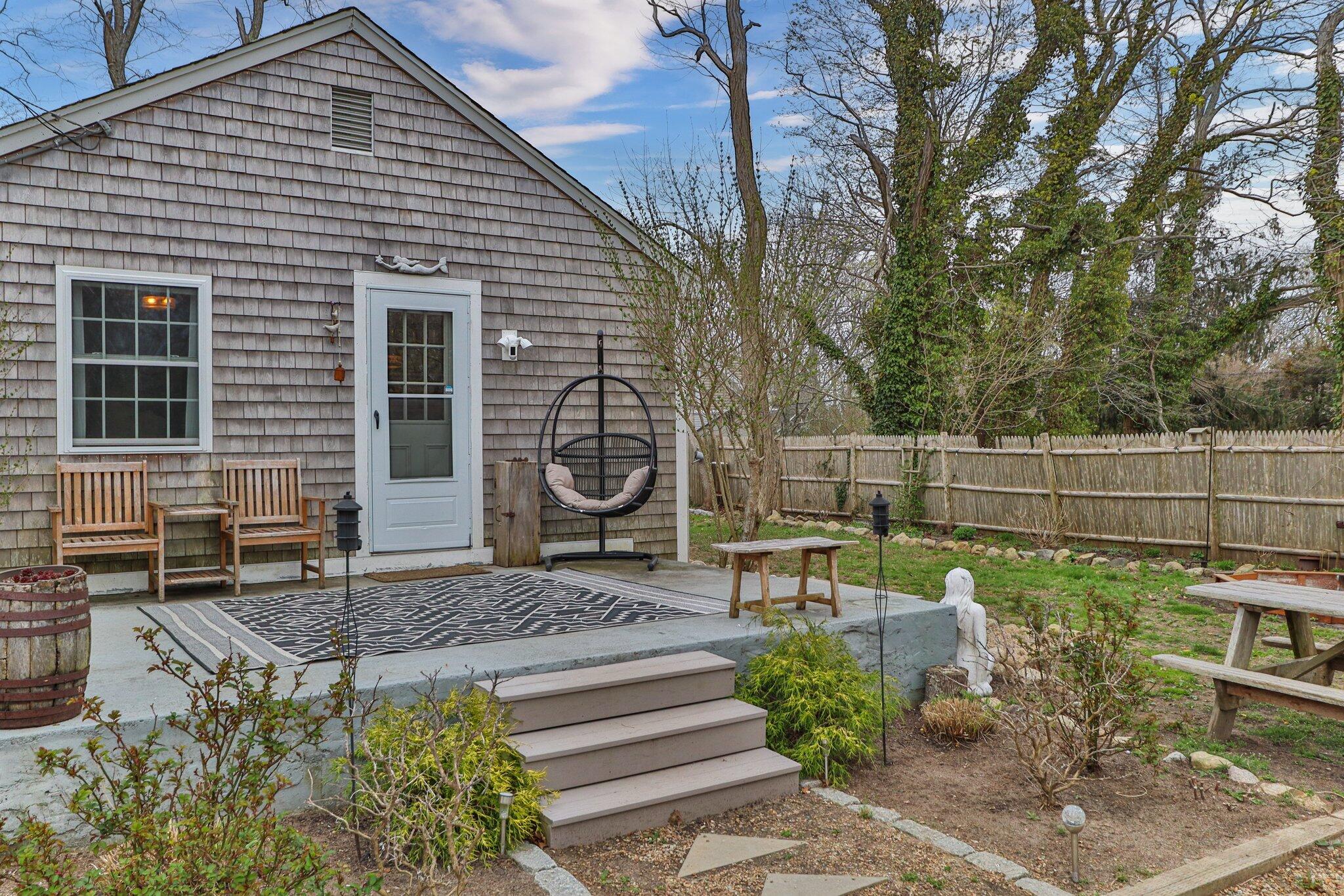582 Massasoit Road Eastham, MA 02642 - Photo 29 of 45 a view of a chairs and table in backyard