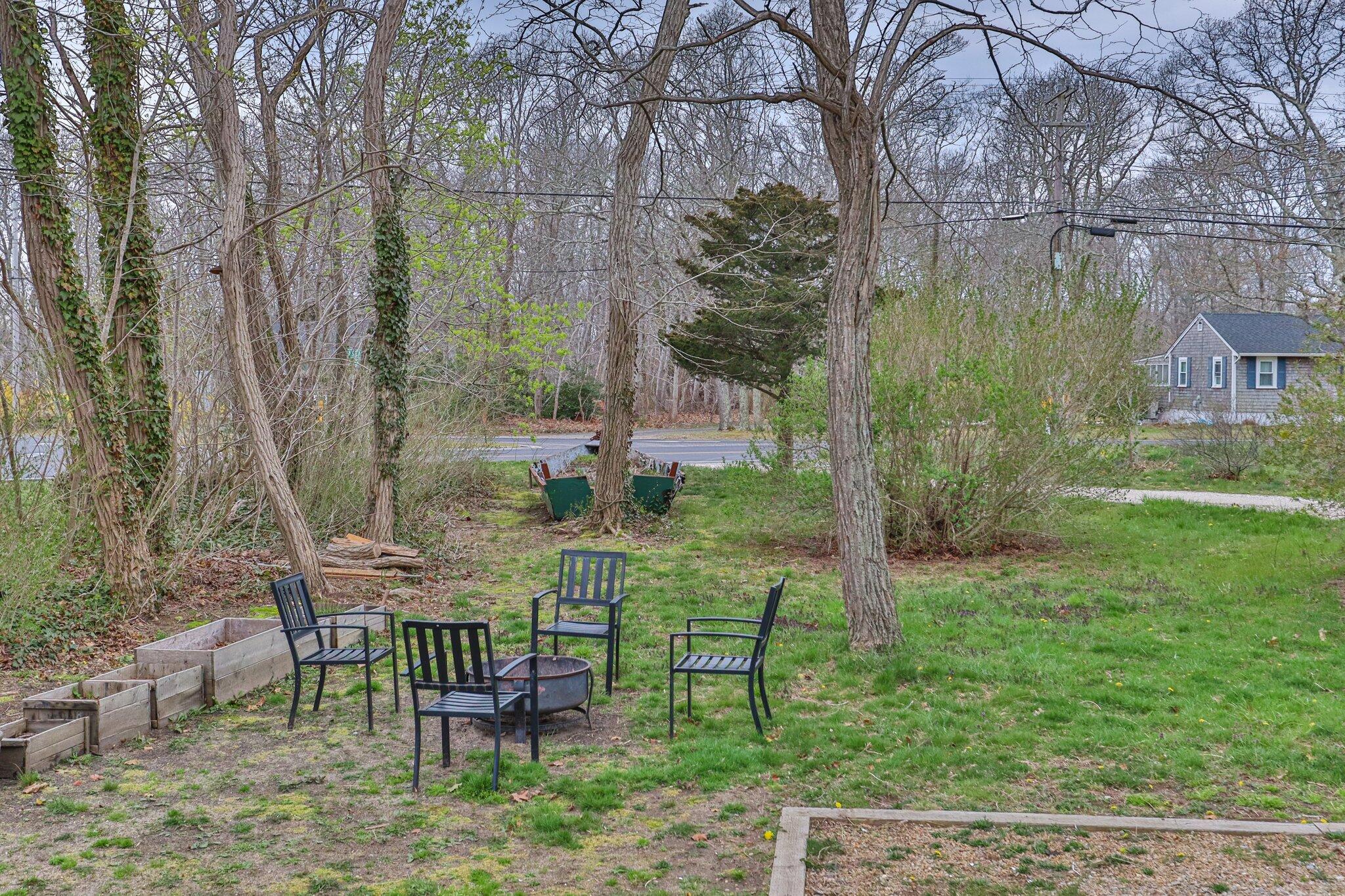 582 Massasoit Road Eastham, MA 02642 - Photo 32 of 45 a view of a chair and table in the garden