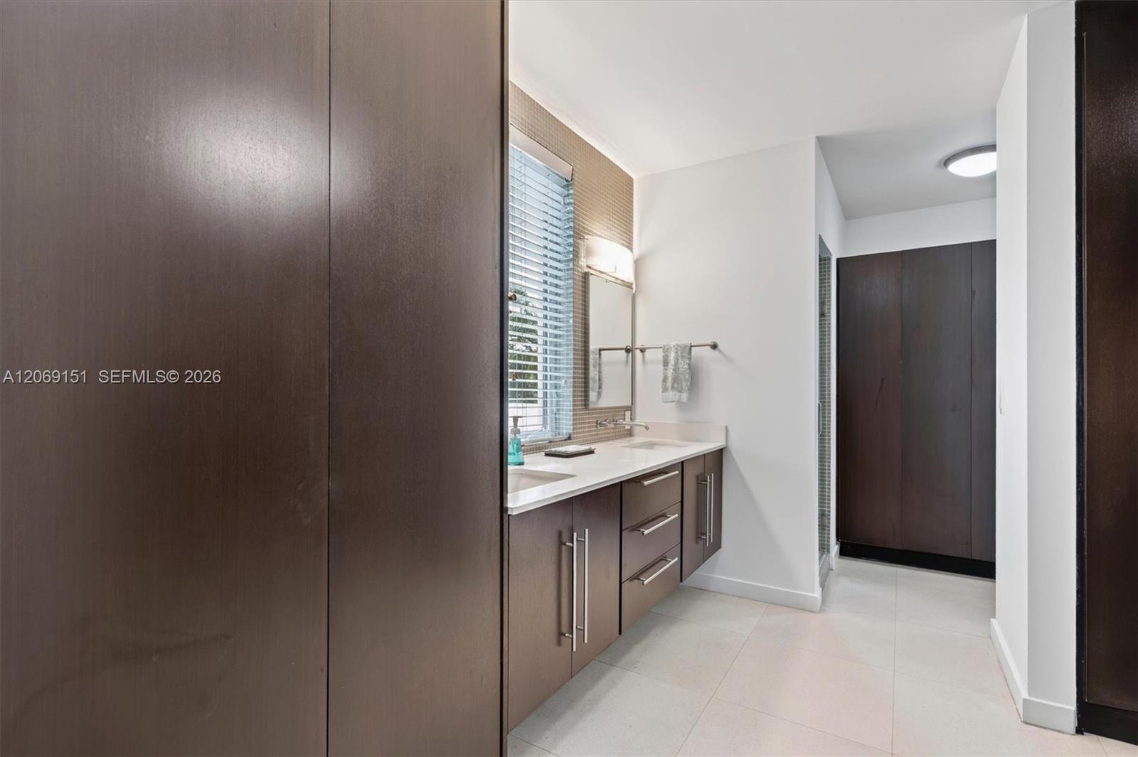 745 Southwest 22nd Road Miami, FL 33129 - Photo 28 of 72 Entry to Primary Bathroom with beautiful custom Wenge Wood closets