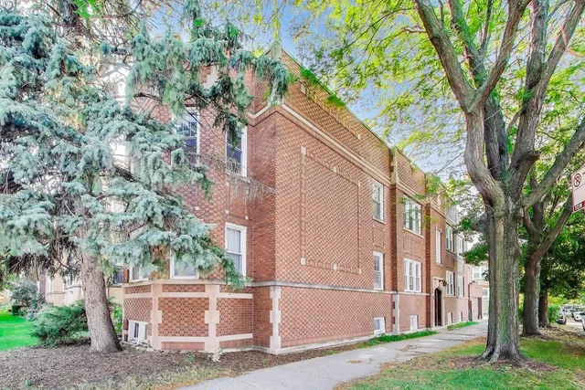 a view of a house with a tree