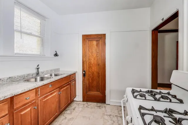 a kitchen with stainless steel appliances granite countertop a sink stove and cabinets