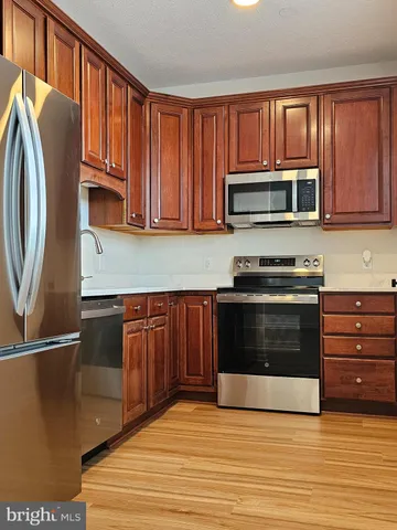 a kitchen with granite countertop a stove and a microwave