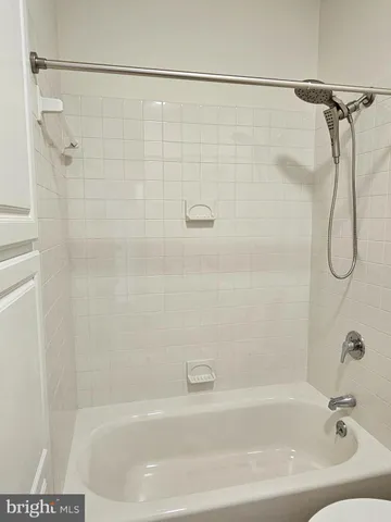 a bathroom with a bath tub with a shower