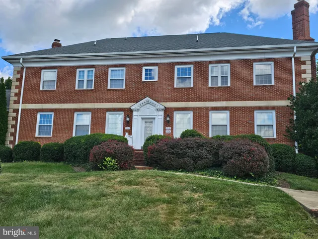 a front view of a house with porch and garden