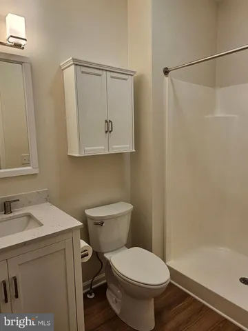 a bathroom with a toilet sink vanity and tub