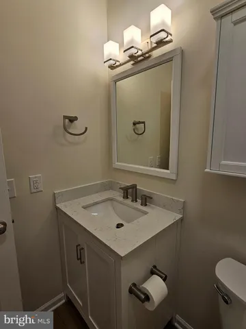 a bathroom with a sink a toilet and mirror
